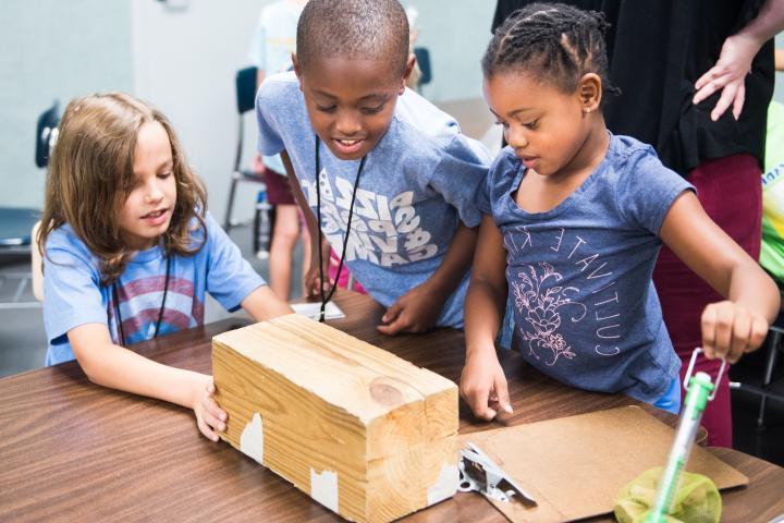 Three young learners enjoying a STEAM Learning Lab at the UTC Challenger Center