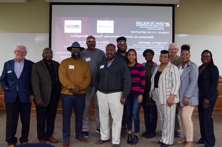 Graduates of the 2023 Urban Vision Initiative program stand with Mike Bradshaw and Bill McDonald during a Community Connect Celebration in the Chattanooga Small Business Development Center.
